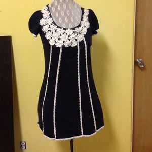 Adorable navy blue dress with floral appliqué!