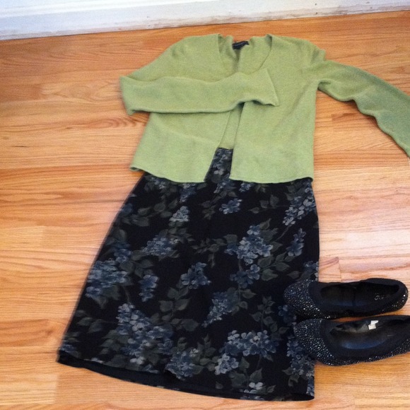 Green cardigan with black floral skirt.