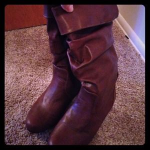 Brown flat boots.
