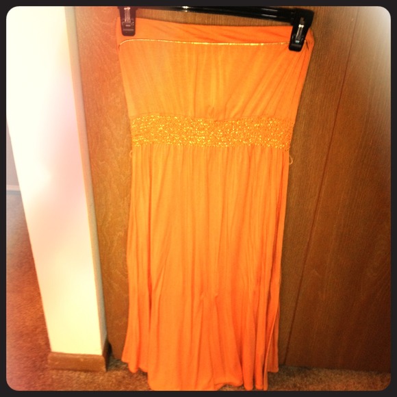 Light orange strapless dress with gold trim