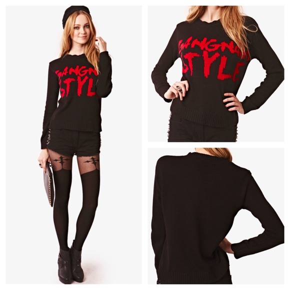 Black sweater with large red gangham style logo.