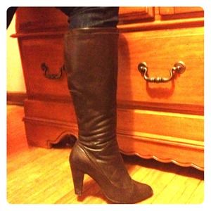Deep brown, leather, knee high heeled boots.