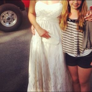 White floor length dress with silver accents.