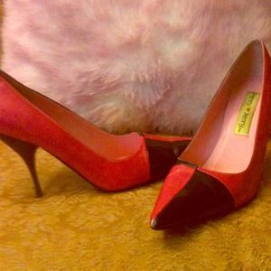 Pink and Black pointy-toe pumps.