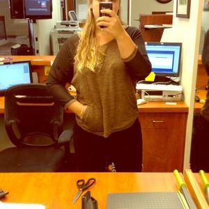 Brown sweater with sheer black sleeves.