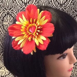 Red &yellow hair flair flower w/ heart center.