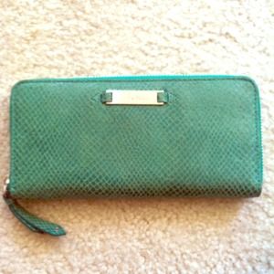 Green Cole Haan snake skin effect wallet.