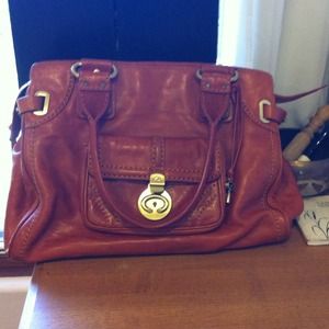 A burnt orange leather purse