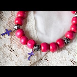 Handmade red wood bracelet with crosses.