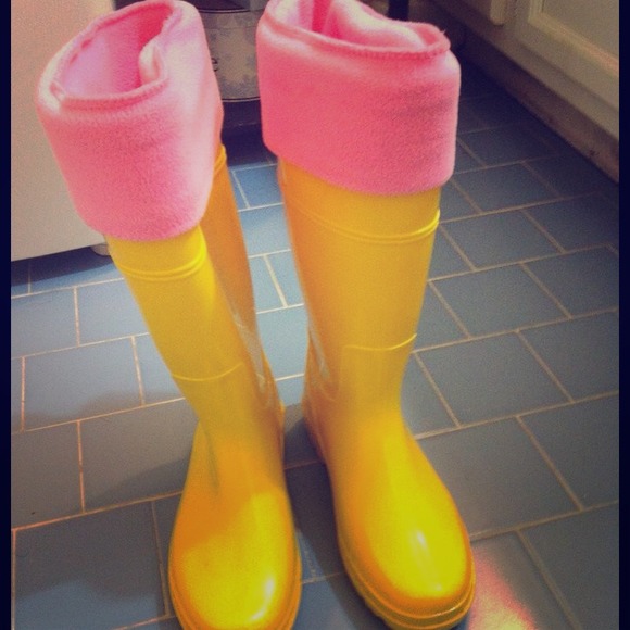 Bright yellow rain boots with cozy pink socks