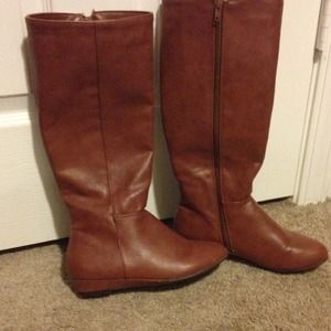 Brown knee length boots.
