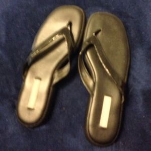 Black vinyl flip flops.