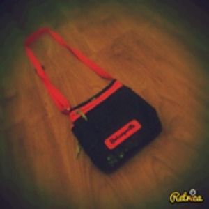 A black and pink sparkled side bag