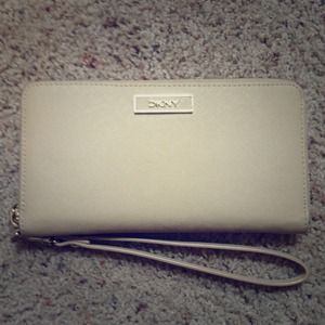 Light tan leather DKNY wallet with pink lining!