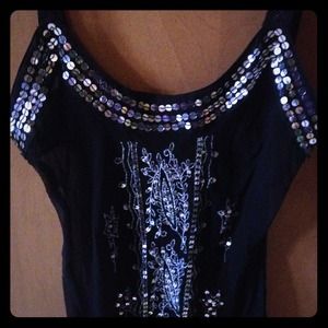 Sheer black tank with sequined embellishment.