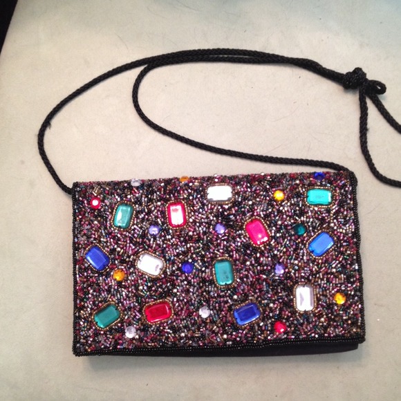Black beaded clutch or has strap.