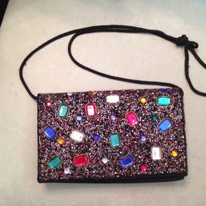 Black beaded clutch or has strap.