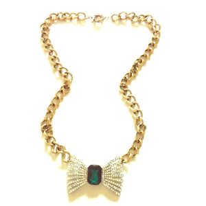 Gold chain pendant necklace with emerald stone.
