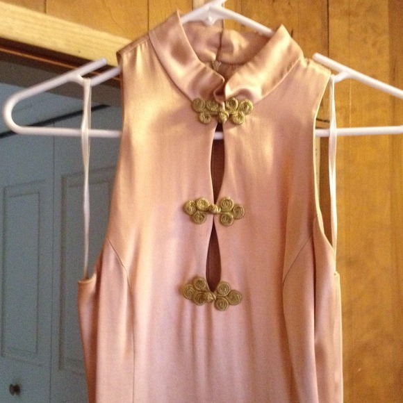 Beige dress with gold details.