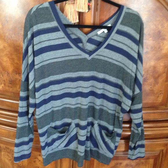 Long sleeve top which buttons in the back.