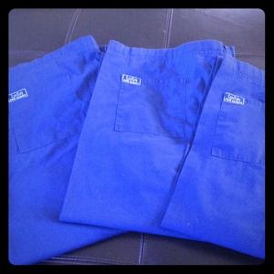 Three navy blue scrub bottoms
