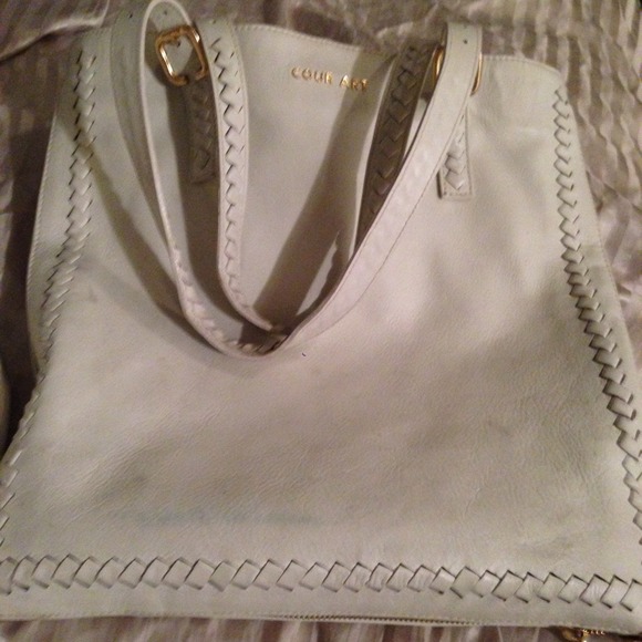 White leather with gold zipper around the purse