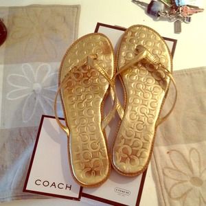 Gold coach flip flops