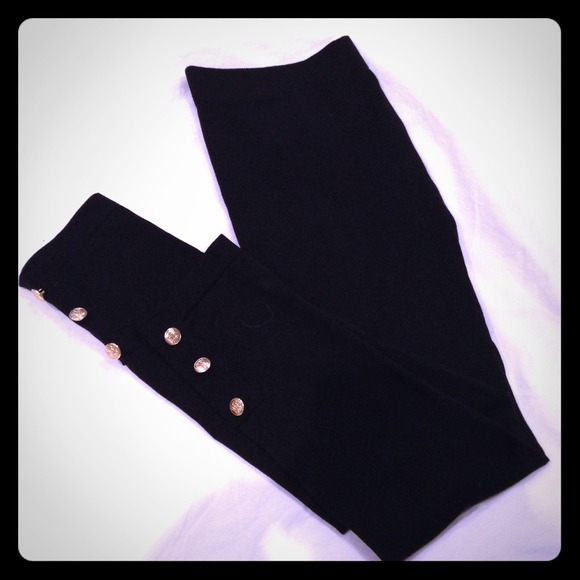 Black leggings with gold button detail.