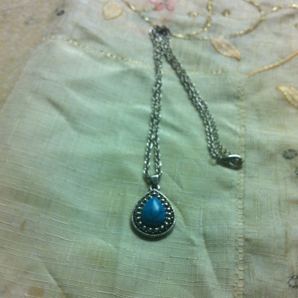A silver chain with a blue stone's pendant