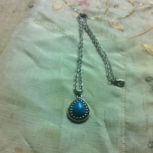 A silver chain with a blue stone's pendant