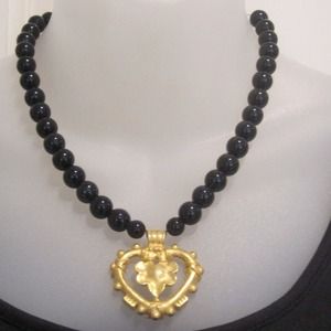 Black jets with gold pendant.