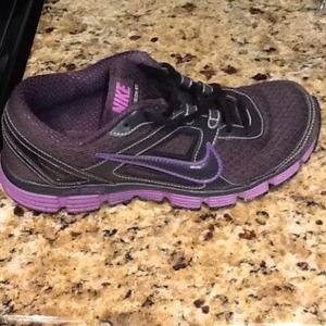 Women's black/purple Nike running shoes.