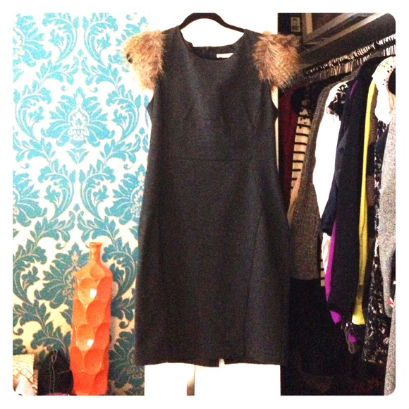 Pointe knit pencil dress with faux fur shoulders.