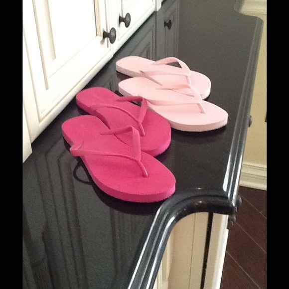 2 pair of pink flip flops