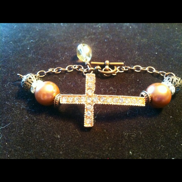 Rose gold side cross bracelet.