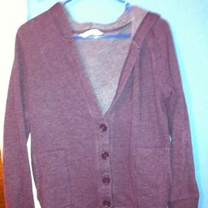 Burgundy cardigan, slightly worn.