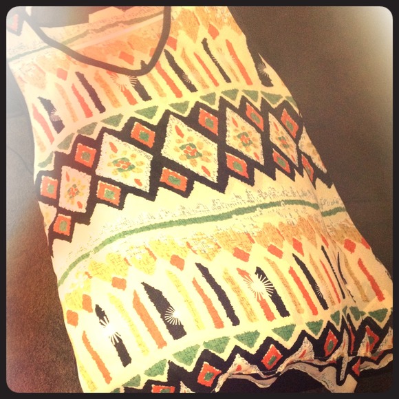 Fiancée high low tank top with cut out sides.