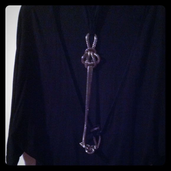 Black short sleeve top. Backless w/ metal accent.