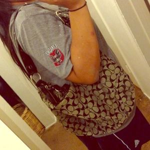 Dark gray coach purse with black signature Cs