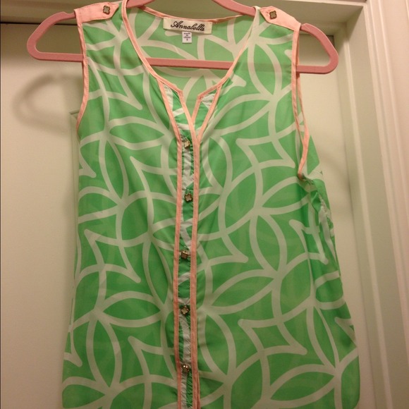 Sleeveless pink and green patterned shirt.