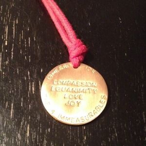 Me & Ro gold necklace on red cord