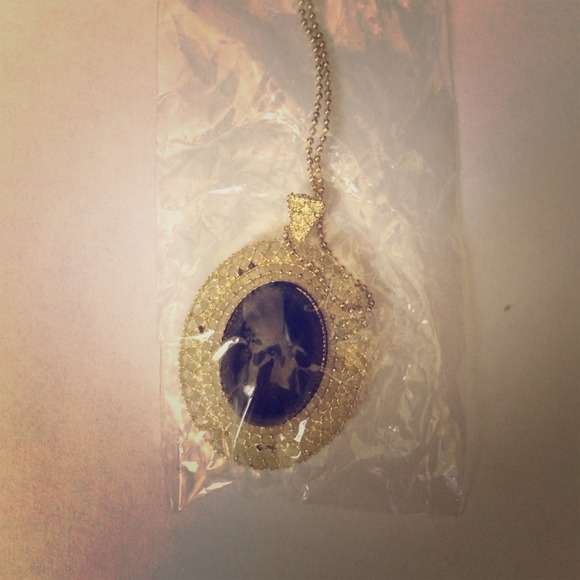 Black pendant long gold necklace.