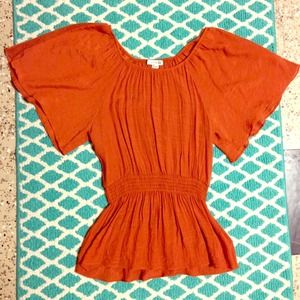 Burnt orange top cinched around the waist