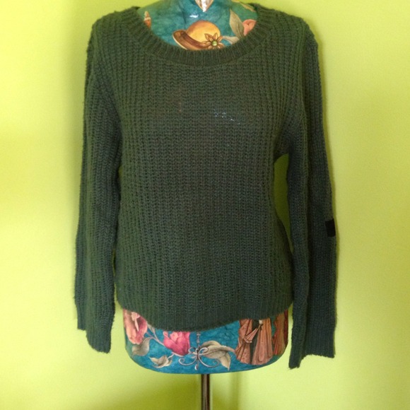 Green sweater with suede cross