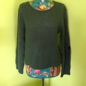 Green sweater with suede cross