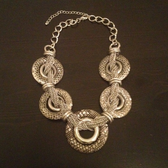 Silver and black colored circle necklace.