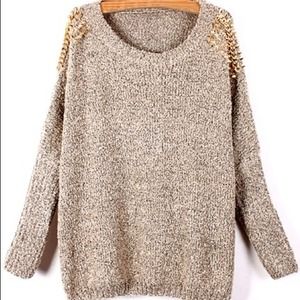 Beige sweater with gold studs.