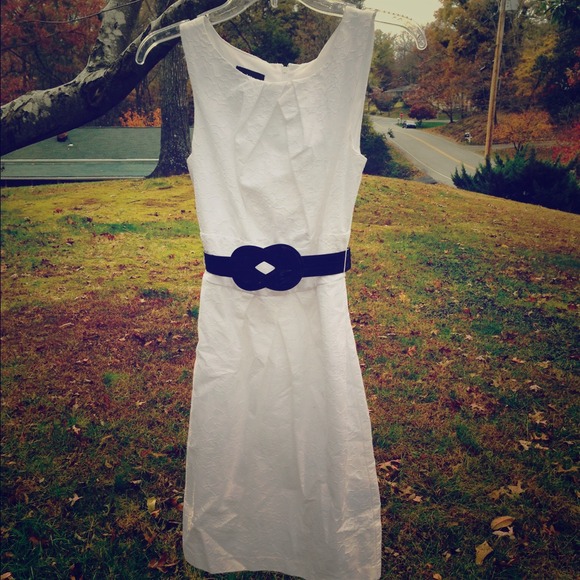 White knee length dress with belt.