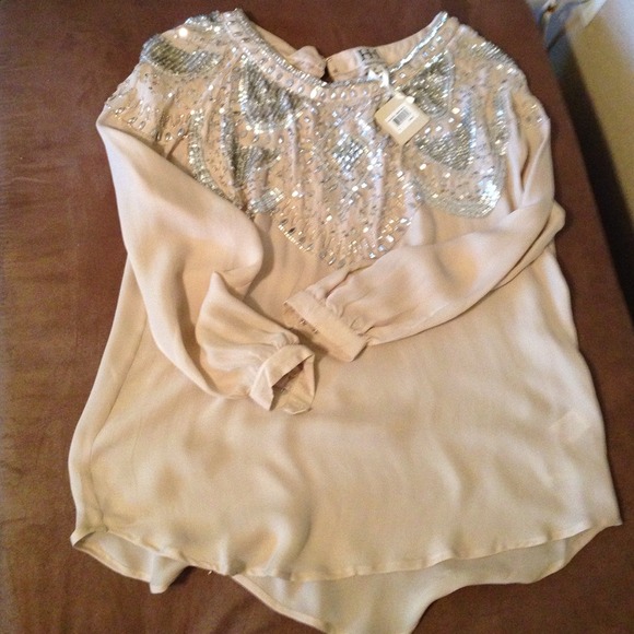 A beautiful blouse with sequins all over the neck!