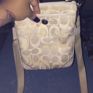 cream colored cross over bag with coin purse